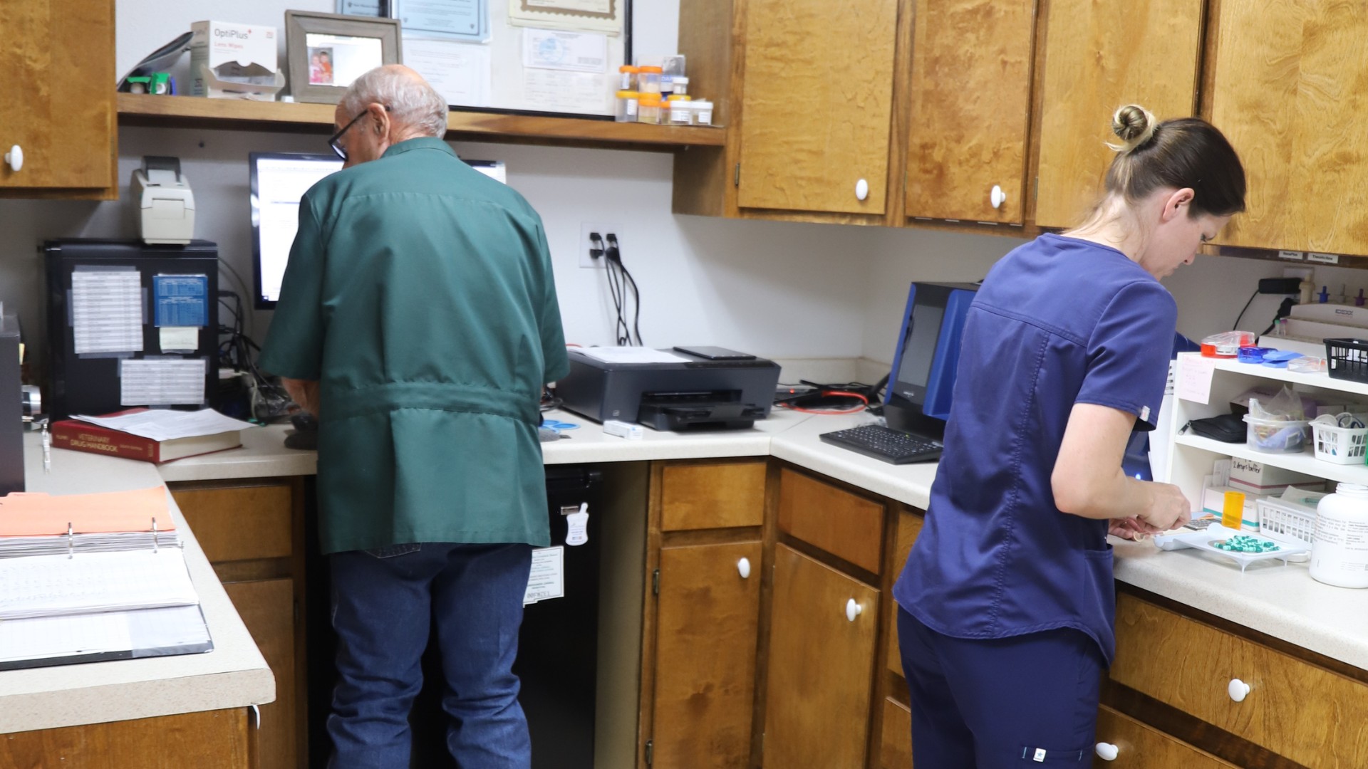 two vet staff working at a lab
